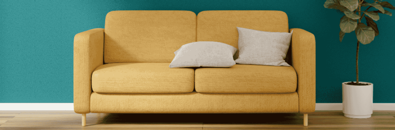 Yellow Sofa Against Teal Wall With Potted Plant - Beautiful Homes