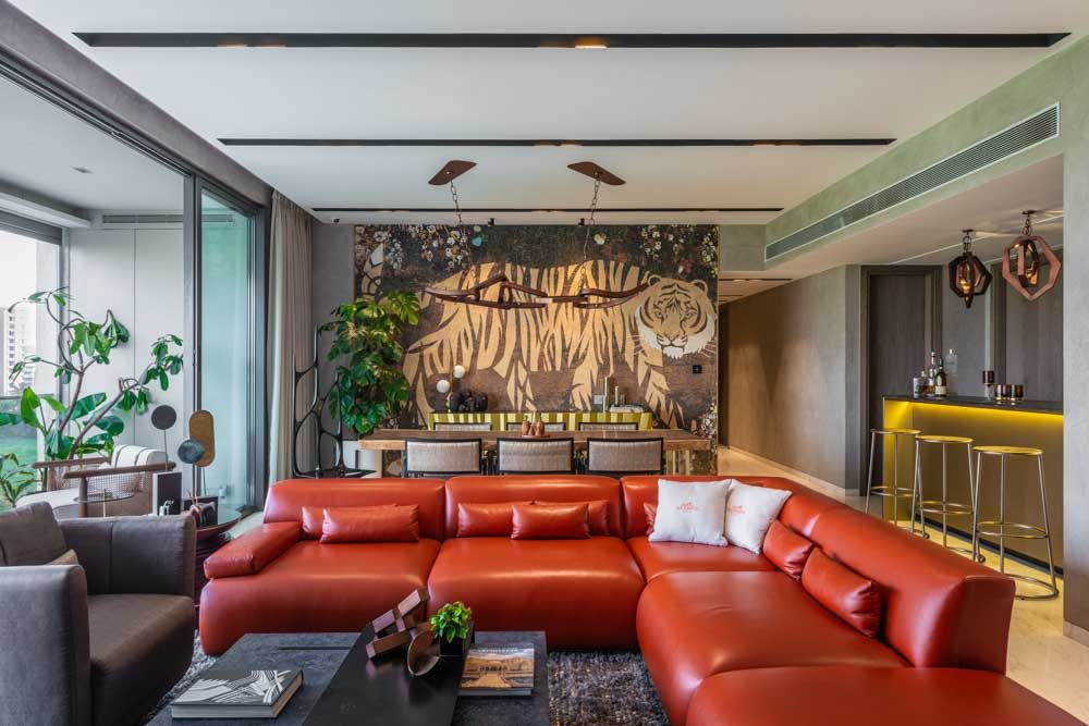 Multipurpose living room design with bar section and red couch - Beautiful Homes