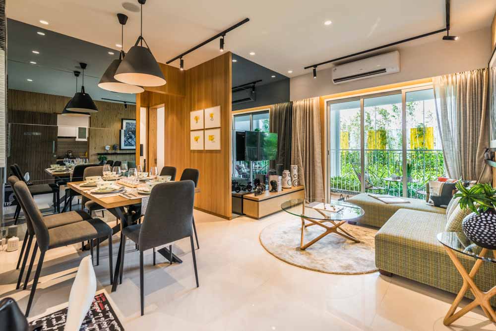 Multipurpose living room design with light wood enhances, L-shaped couch and a soft rug  - Beautiful Homes