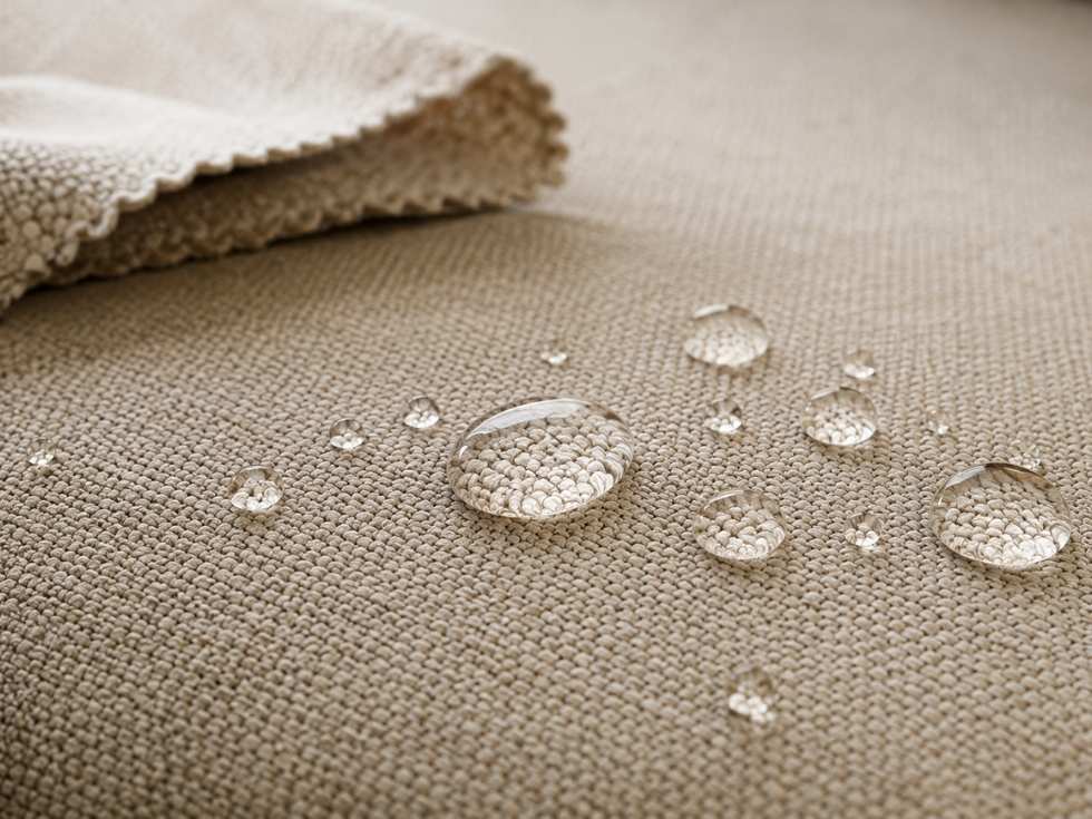 Water droplets beading on stain resistant upholstery fabric with protective coating - Beautiful Homes