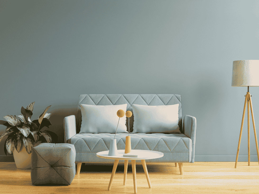 Minimalist Living Room Featuring A Light Blue Sofa, Round Coffee Table, And Potted Plant - Beautiful Homes