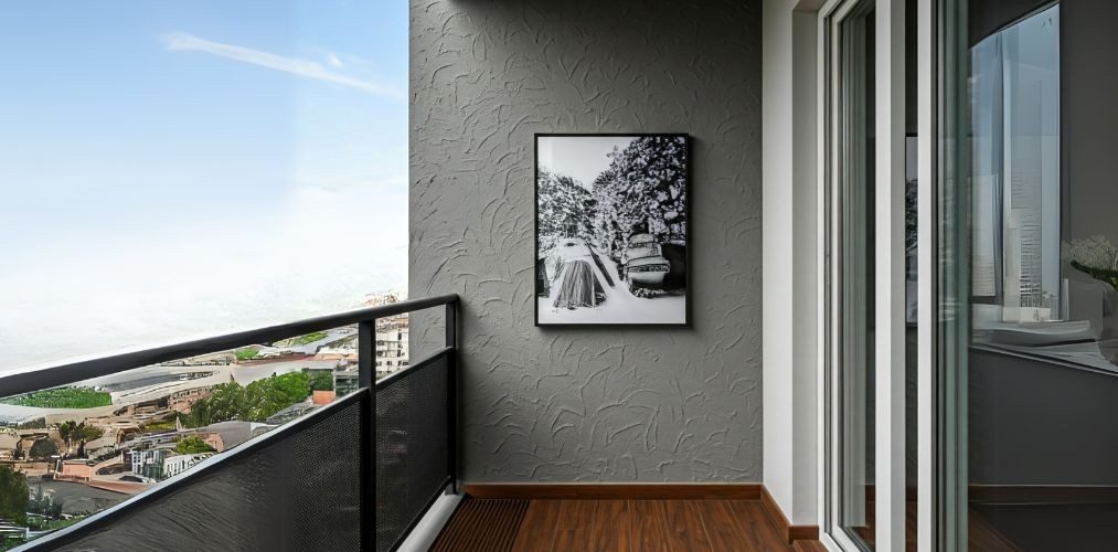Balcony with black railing and textured grey wall - Beautiful Homes