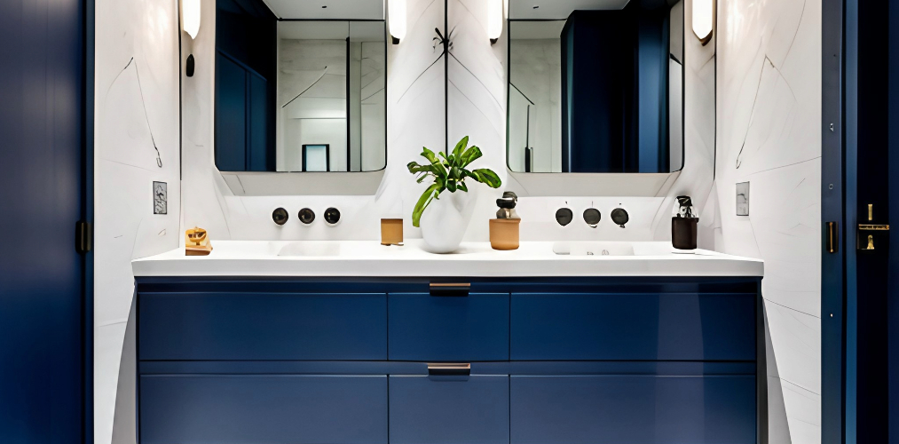 Minimalist bathroom with blue vanity unit and white marble tiles-Beautiful Homes