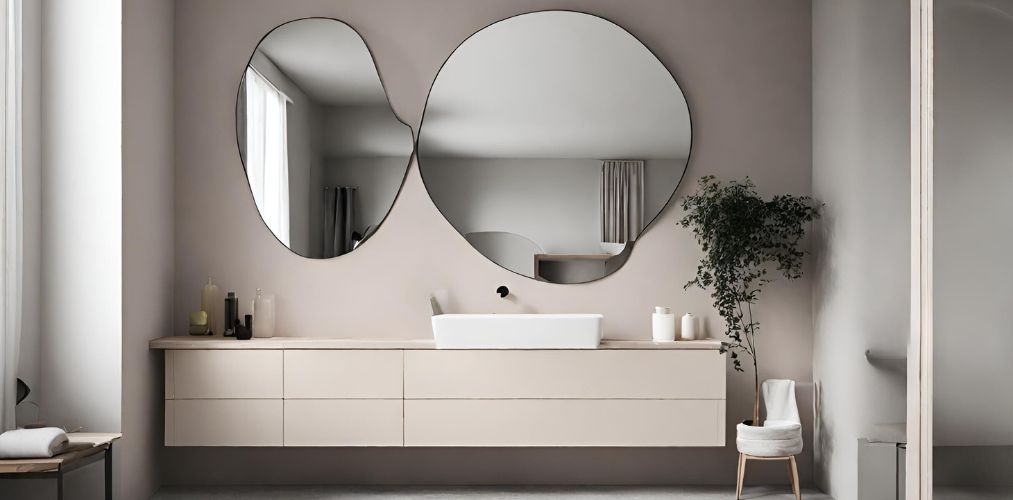 Modern neutral bathroom with abstract shaped mirrors - Beautiful Homes