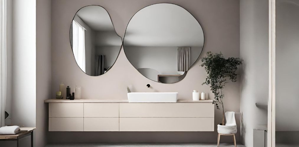 Modern neutral bathroom with abstract shaped mirrors - Beautiful Homes