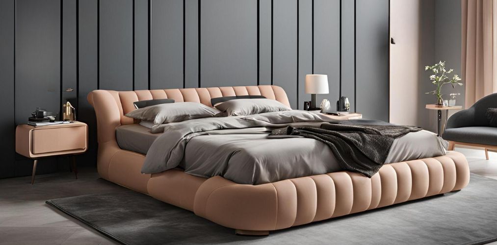 Peach upholstered bed against grey wall backdrop - Beautiful Homes