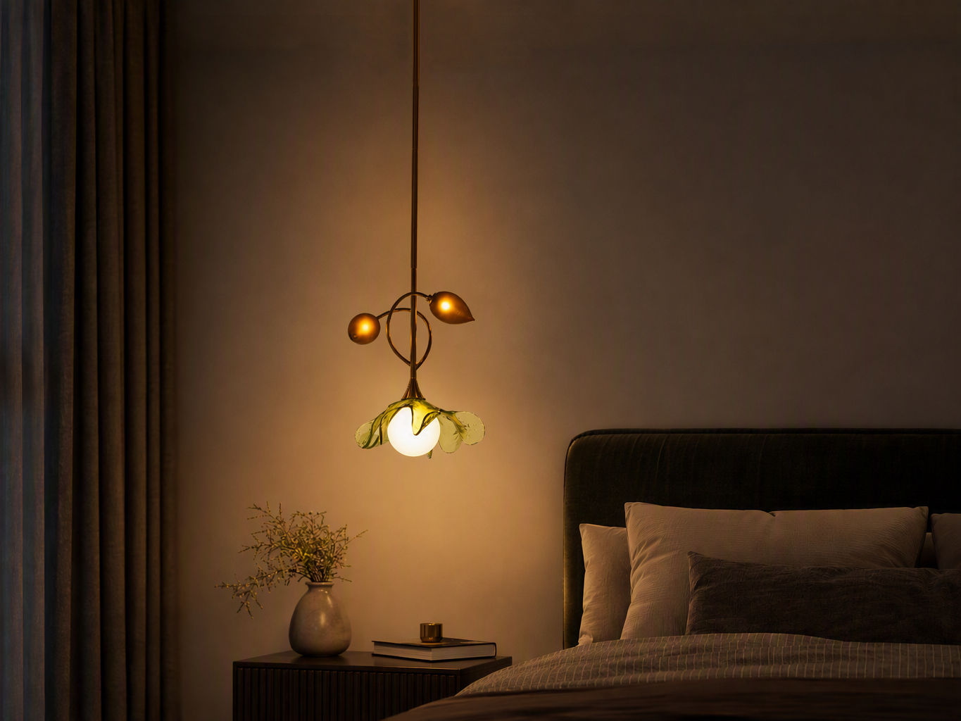 Modern botanical pendant light with delicate green glass petals suspended beside a bed - Beautiful Homes
