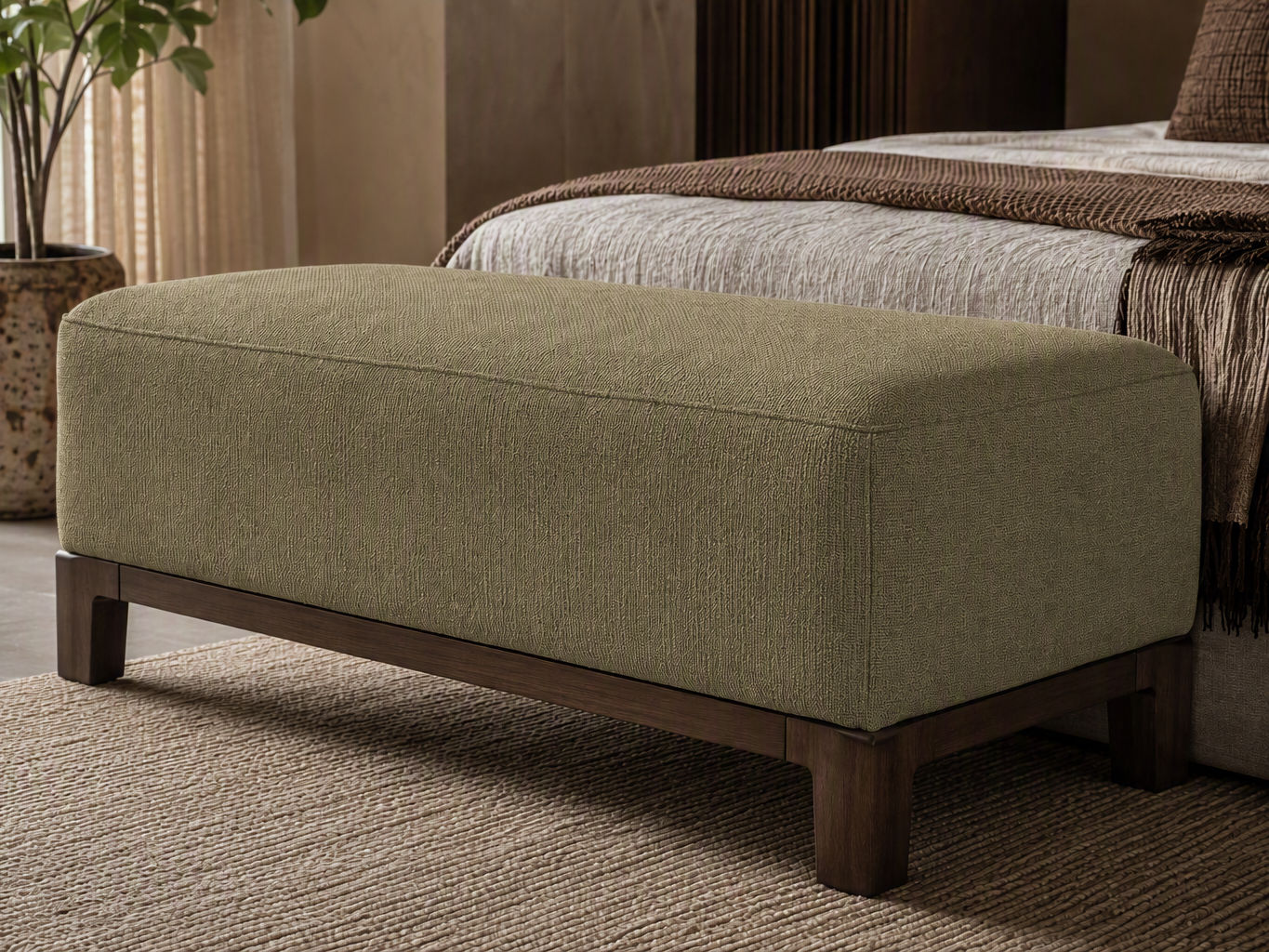 Modern upholstered end-of-bed ottoman bench with dark wooden legs in a cozy neutral bedroom - Beautiful Homes