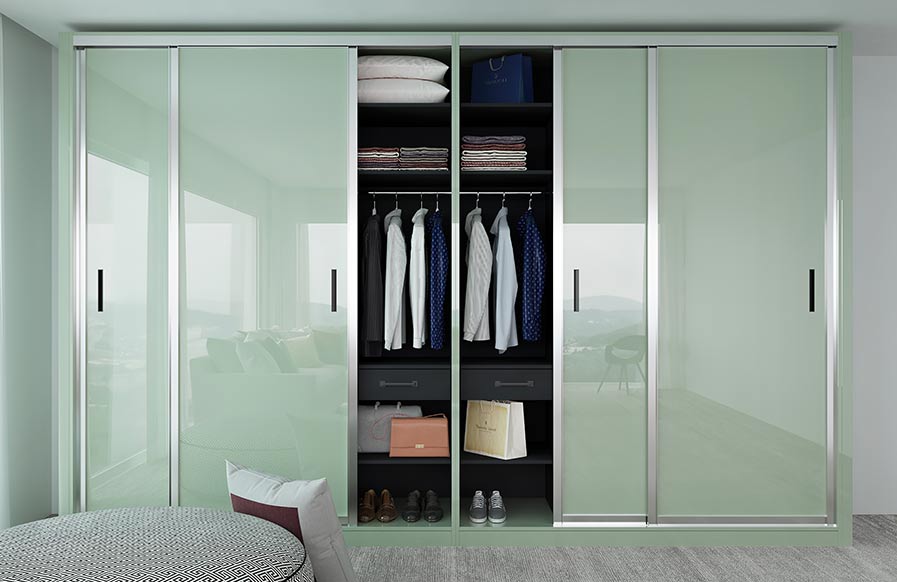 Bedroom design with modular fitted cupboard with green glass doors - Beautiful Homes