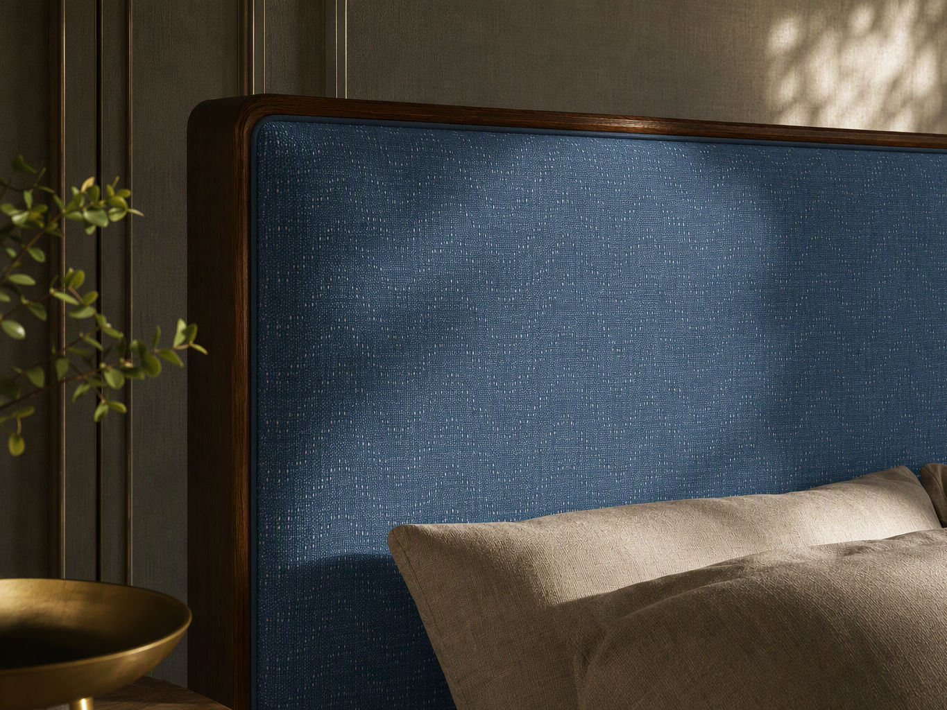 Bed furnishing with a rounded dark wood headboard frame, textured blue upholstered panel, and neutral linen pillows - Beautiful Homes