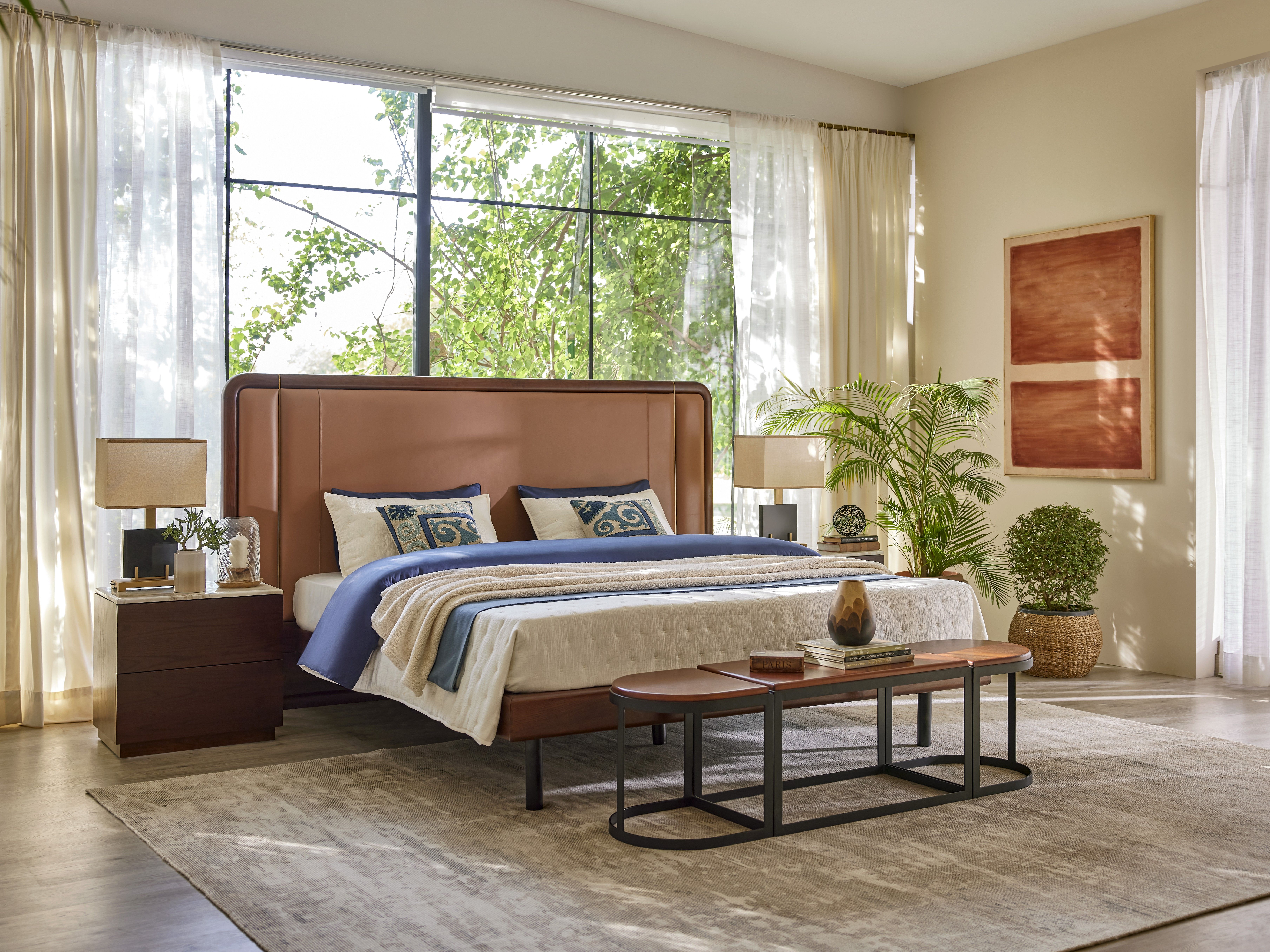 Elegant bedroom featuring a leather headboard and large window - Beautiful Homes