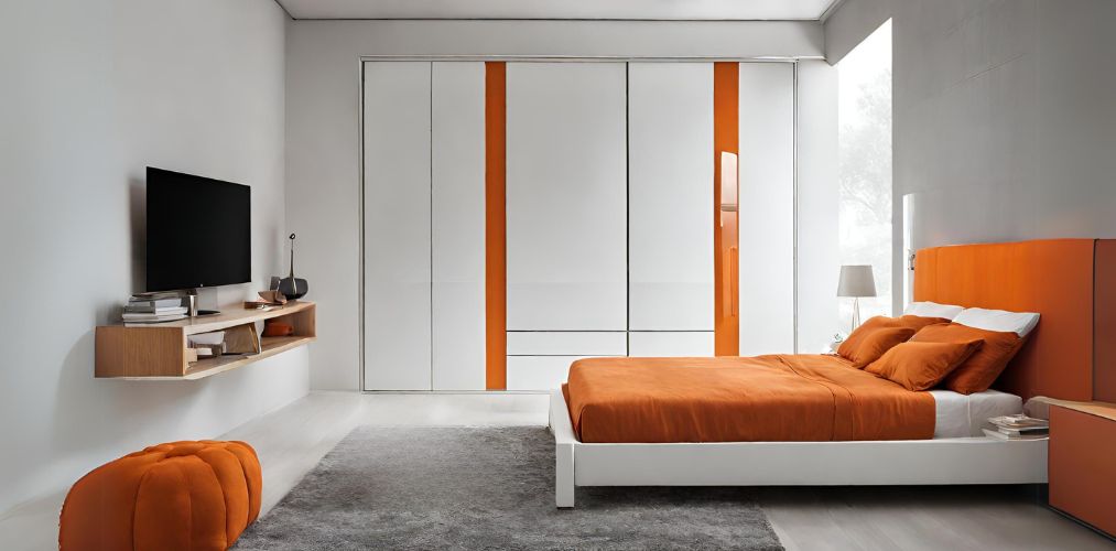 Orange and white minimalistic bedroom with white wardrobe-Beautiful Homes