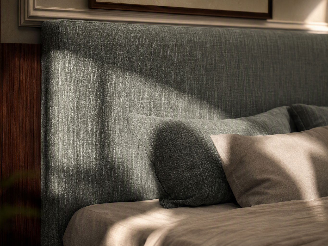 Close-up of a modern textured grey upholstered headboard with matching pillows and neutral bed linen - Beautiful Homes