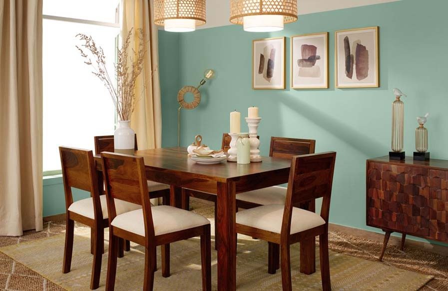 Warm dining room design with pastel blue wall colour - Beautiful Homes