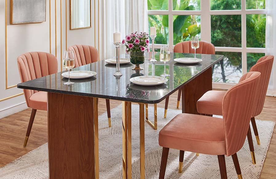 Pastel orange coloured dining room design with luxe dining table set - Beautiful Homes