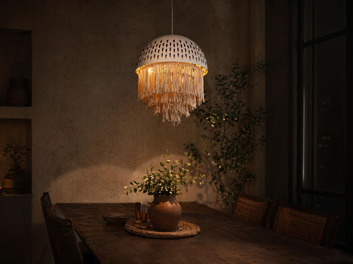 Dome-shaped pendant light with a white perforated shade and cascading cream macrame fringe - Beautiful Homes