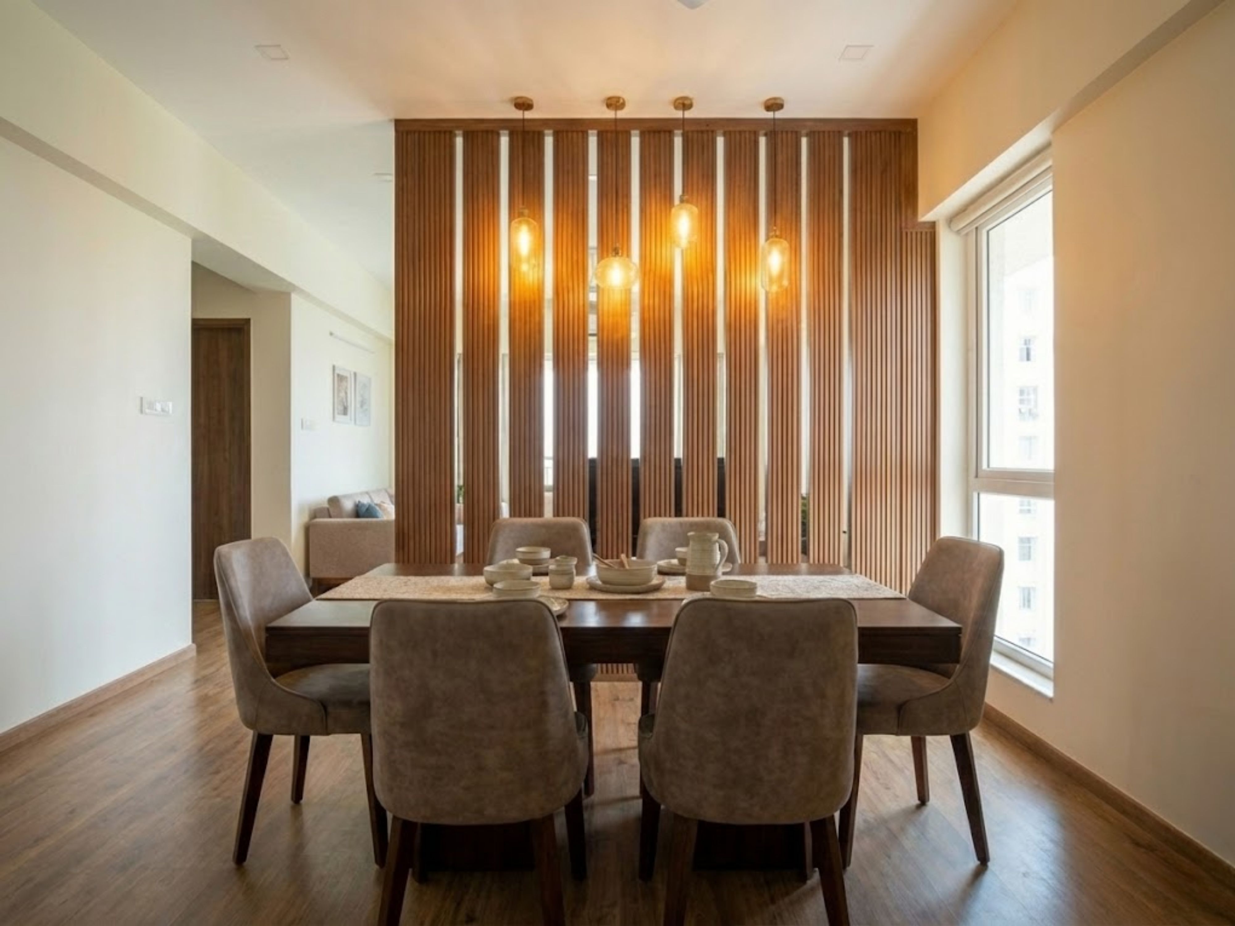 Modern dining room with wood accents and lighting - Beautiful Homes