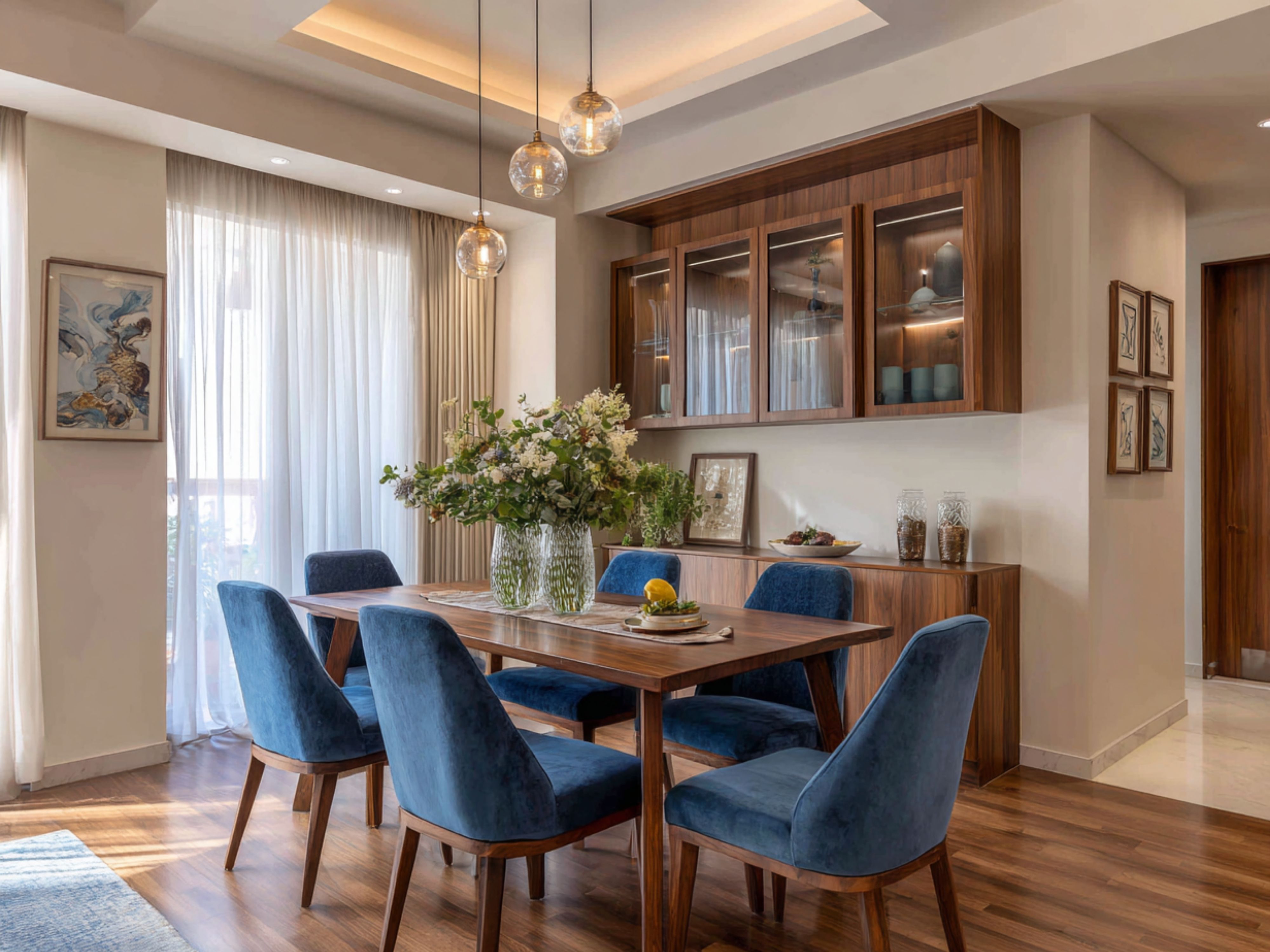 Dining room with blue chairs and wooden table - Beautiful Homes