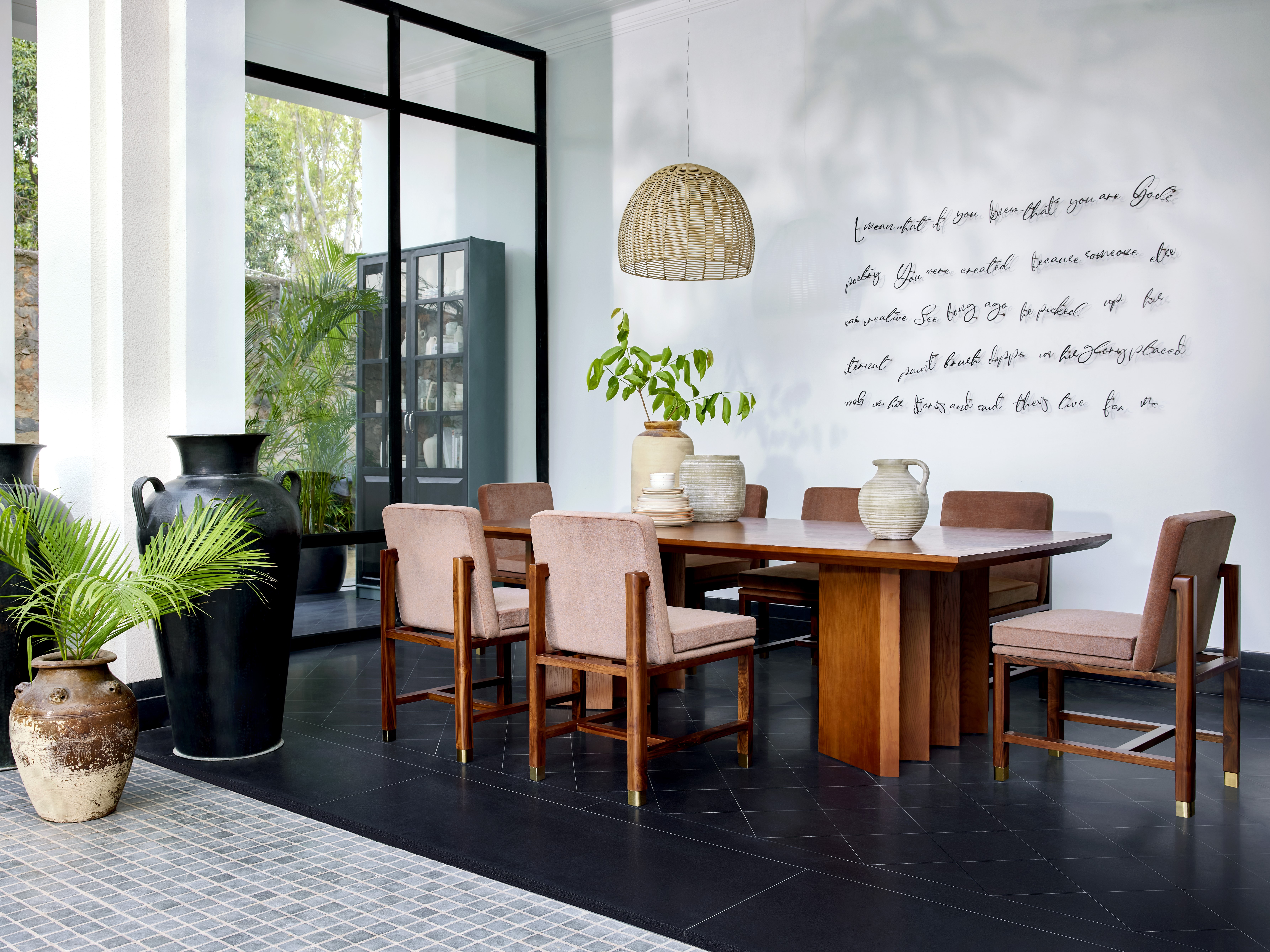 Elegant dining table with chairs and greenery - Beautiful Homes