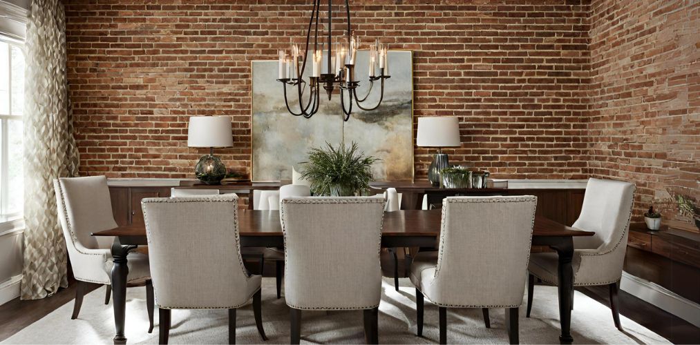 Rustic dining room with brick accent wall and upholstered chairs - Beautiful Homes