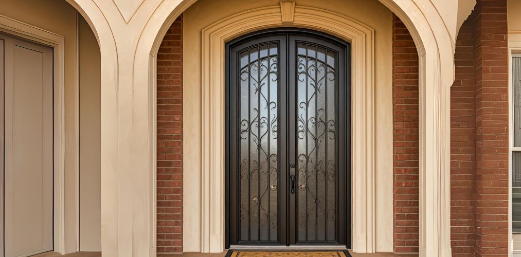 Arched main door design with glass and ironwork - Beautiful Homes