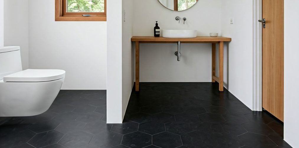 Bathroom with black hexagon tiles and wooden accents - Beautiful Homes