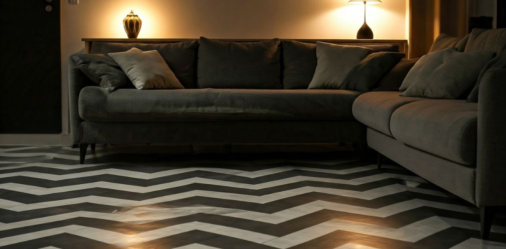 Living room with grey sofa and chevron flooring - Beautiful Homes