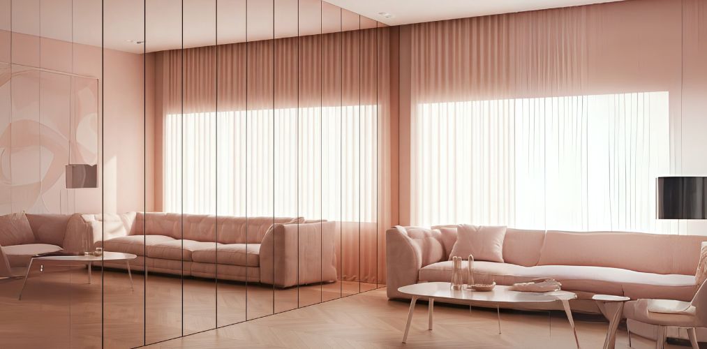 Reflective glass wall in modern living room with pink décor - Beautiful Homes