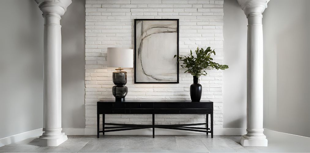 Foyer design with black console and white brick accent wall-Beautiful Homes