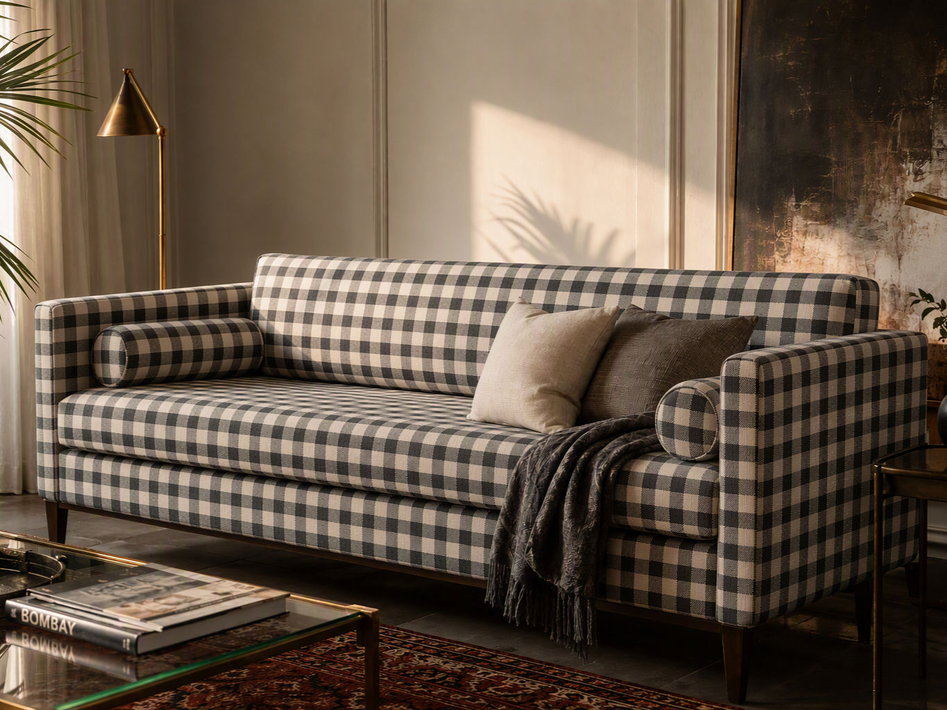 Three-seater sofa upholstered in black and white gingham fabric, styled with neutral throw pillows - Beautiful Homes