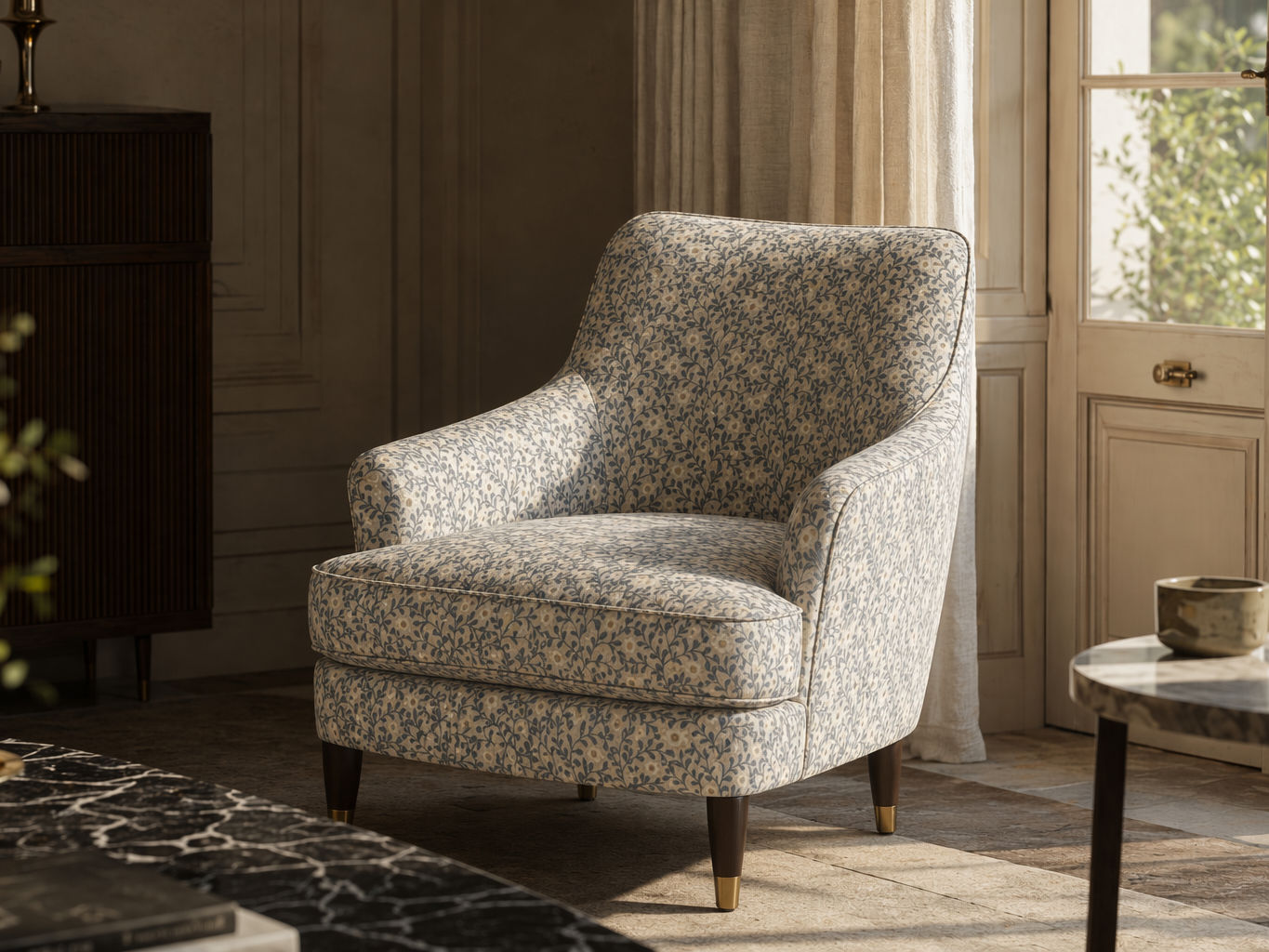 Upholstered accent armchair with a soft botanical print, curved backrest, rounded arms, and dark wooden legs - Beautiful Homes