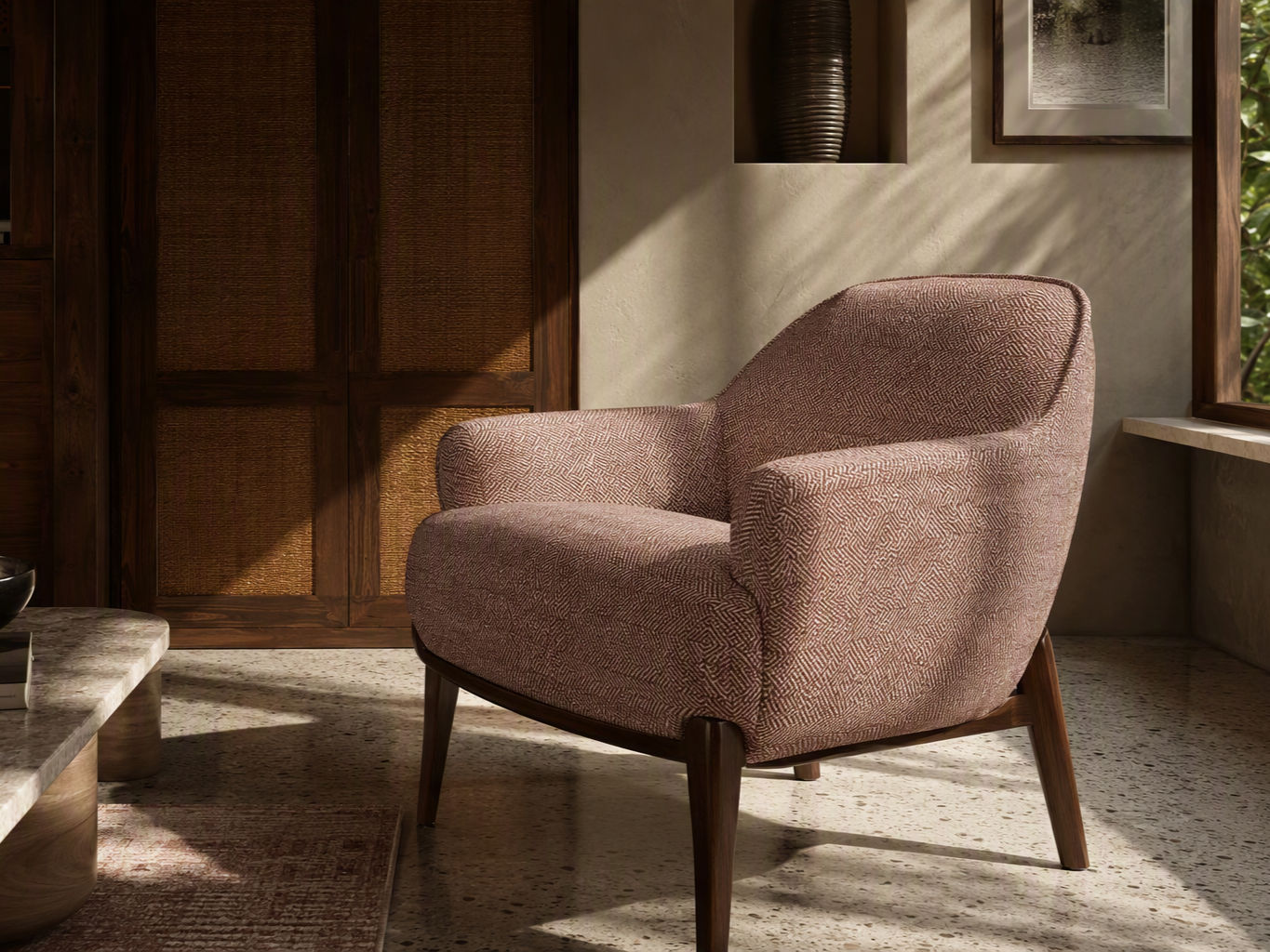 Curved armchair upholstered in textured dusty rose woven fabric with a dark wooden frame and tapered legs - Beautiful Homes