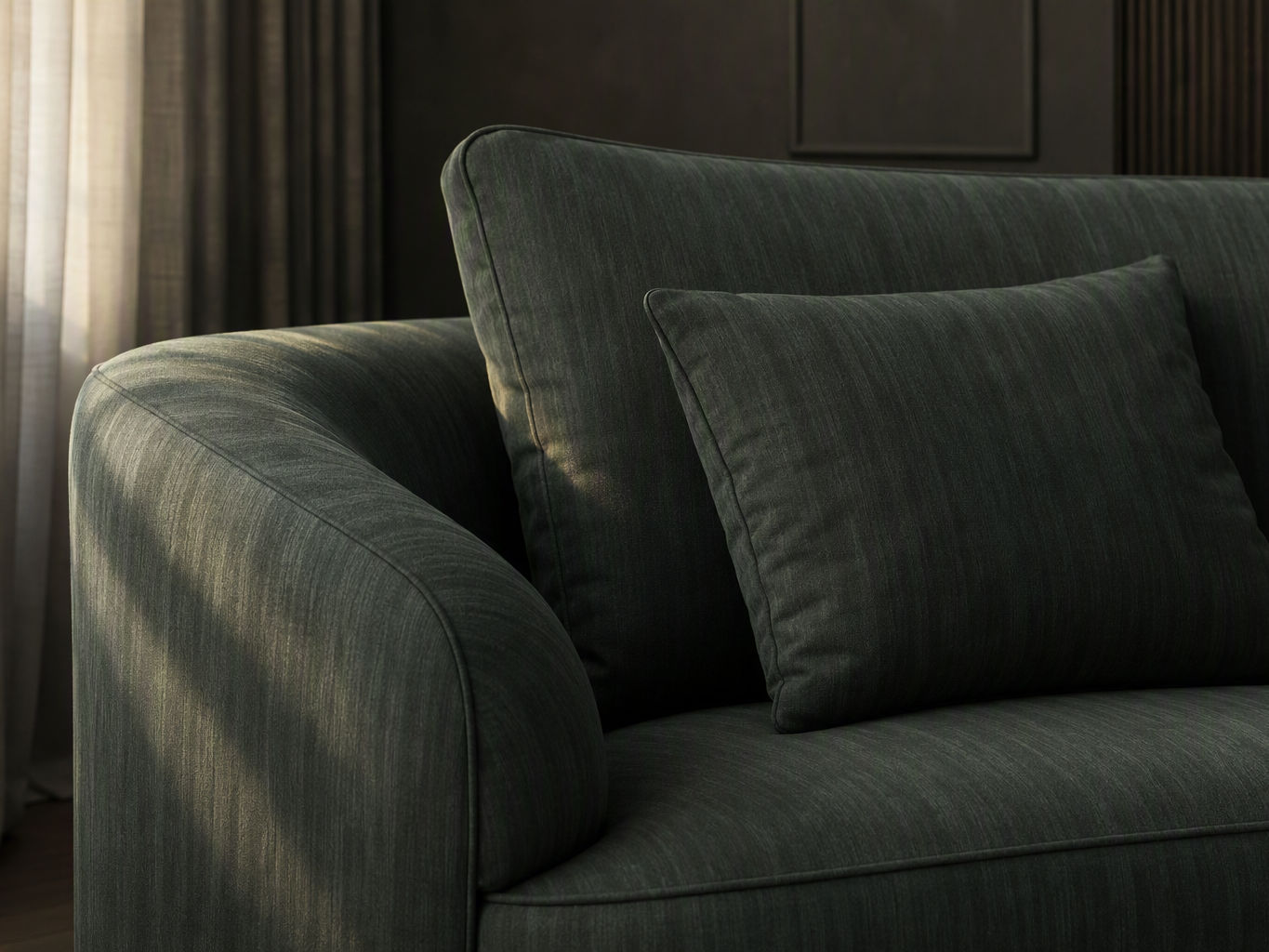 Close-up of a modern sofa featuring textured forest green fabric upholstery with a matching cushion - Beautiful Homes