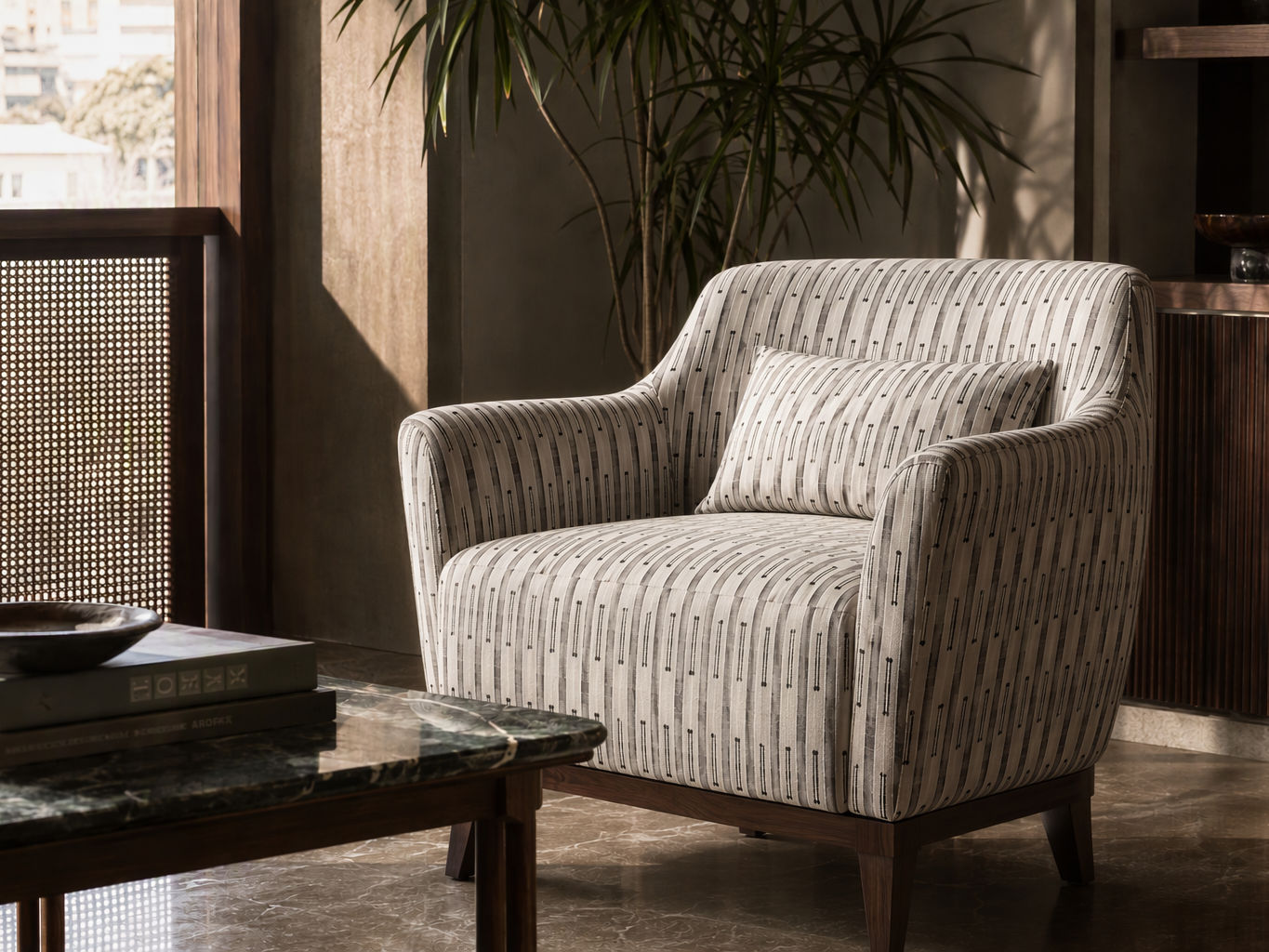Light beige armchair with grey striped upholstery, a matching lumbar cushion, and a dark wooden base, positioned in a refined living room beside a marble table and indoor plant - Beautiful Homes