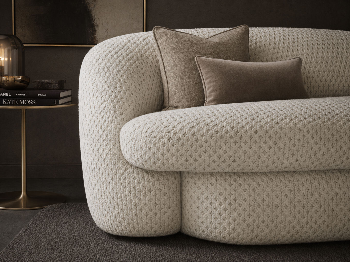 Cream curved sofa with richly textured quilted upholstery, layered brown accent cushions, and a sculptural profile in an elegant modern interior - Beautiful Homes