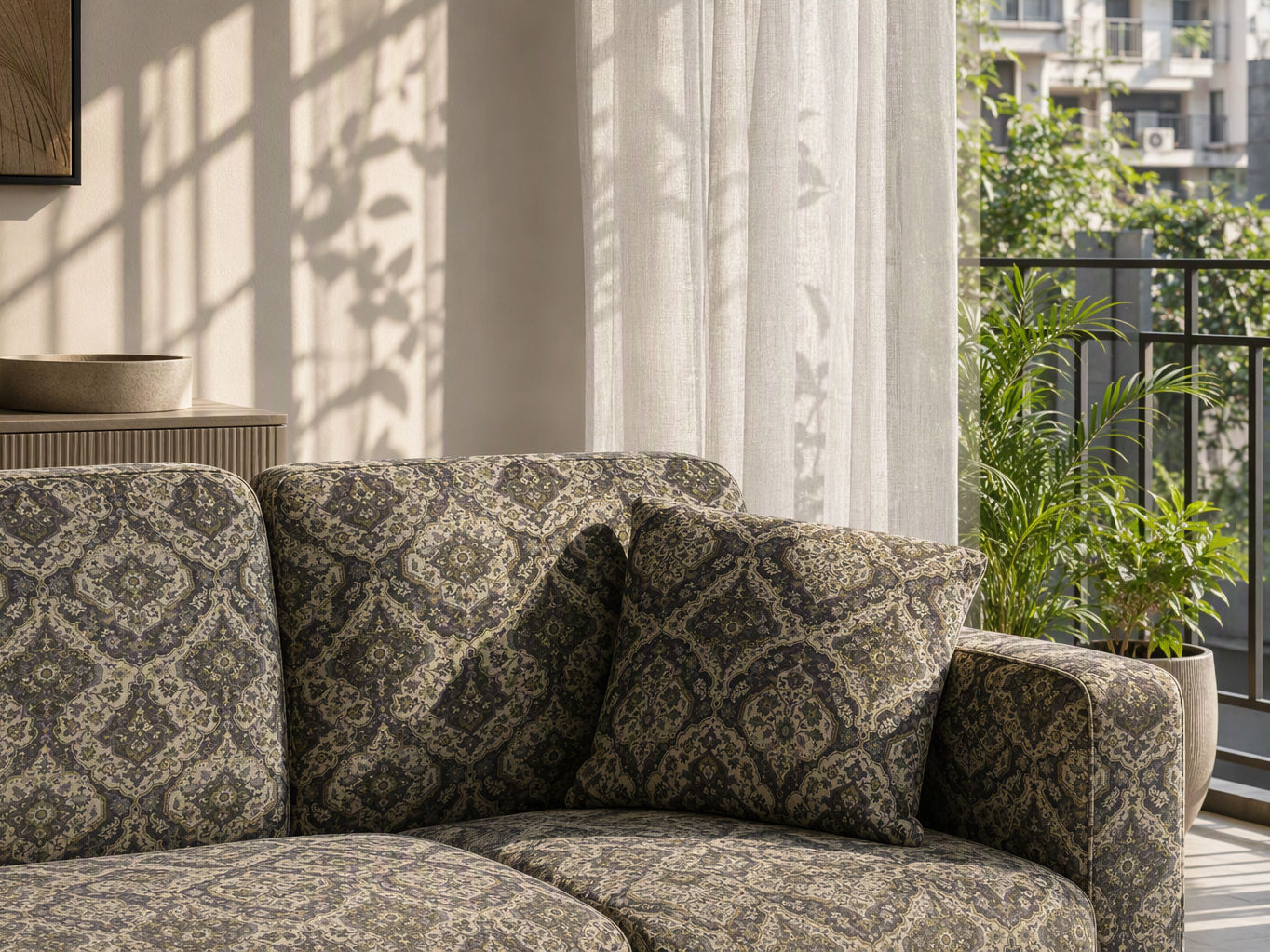 Living room furnishing with a patterned green and charcoal upholstered sectional sofa, matching accent cushion, and woven fabric texture - Beautiful Homes