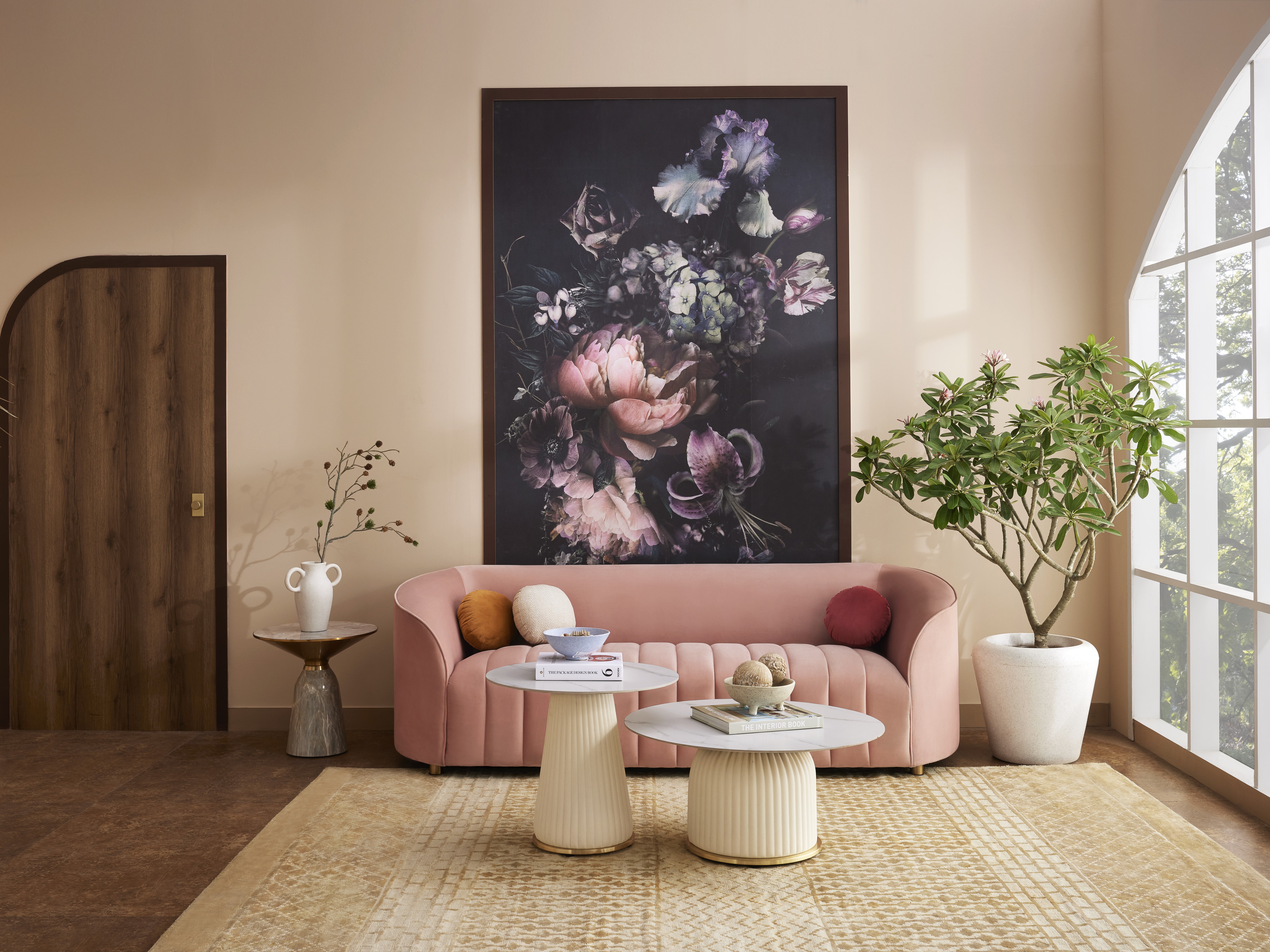 Living room with pink sofa and floral wall art - Beautiful Homes