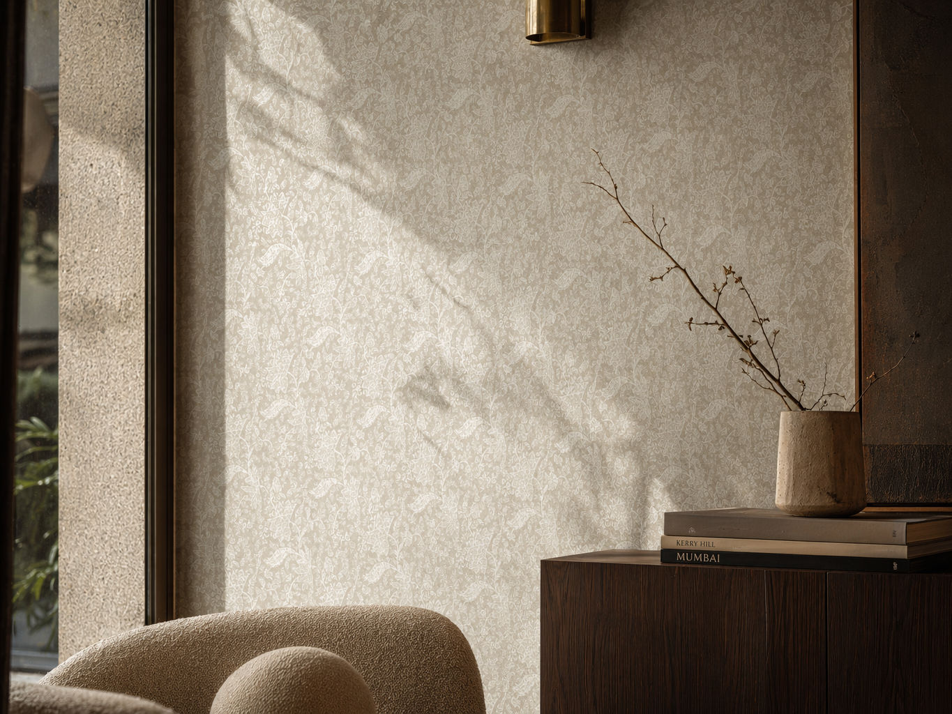 Beige wallpaper with a delicate floral damask pattern, styled behind a dark wood cabinet - Beautiful Homes