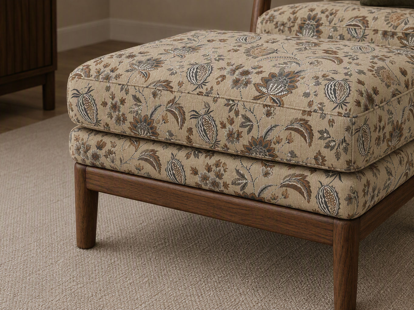 Plush upholstered ottoman featuring a beige botanical print fabric and solid walnut wood legs - Beautiful Homes