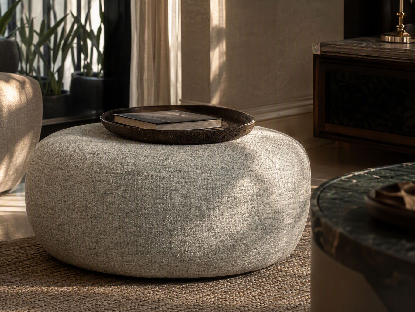 Round low-profile pouf upholstered in textured light grey woven fabric - Beautiful Homes