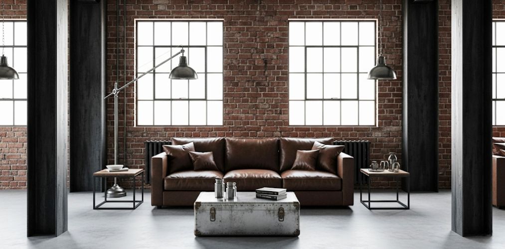 Living room with brick wall and leather sofa - Beautiful Homes