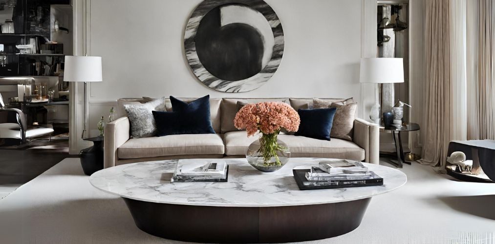 Living room with beige sofa and marble oval coffee table - Beautiful Homes