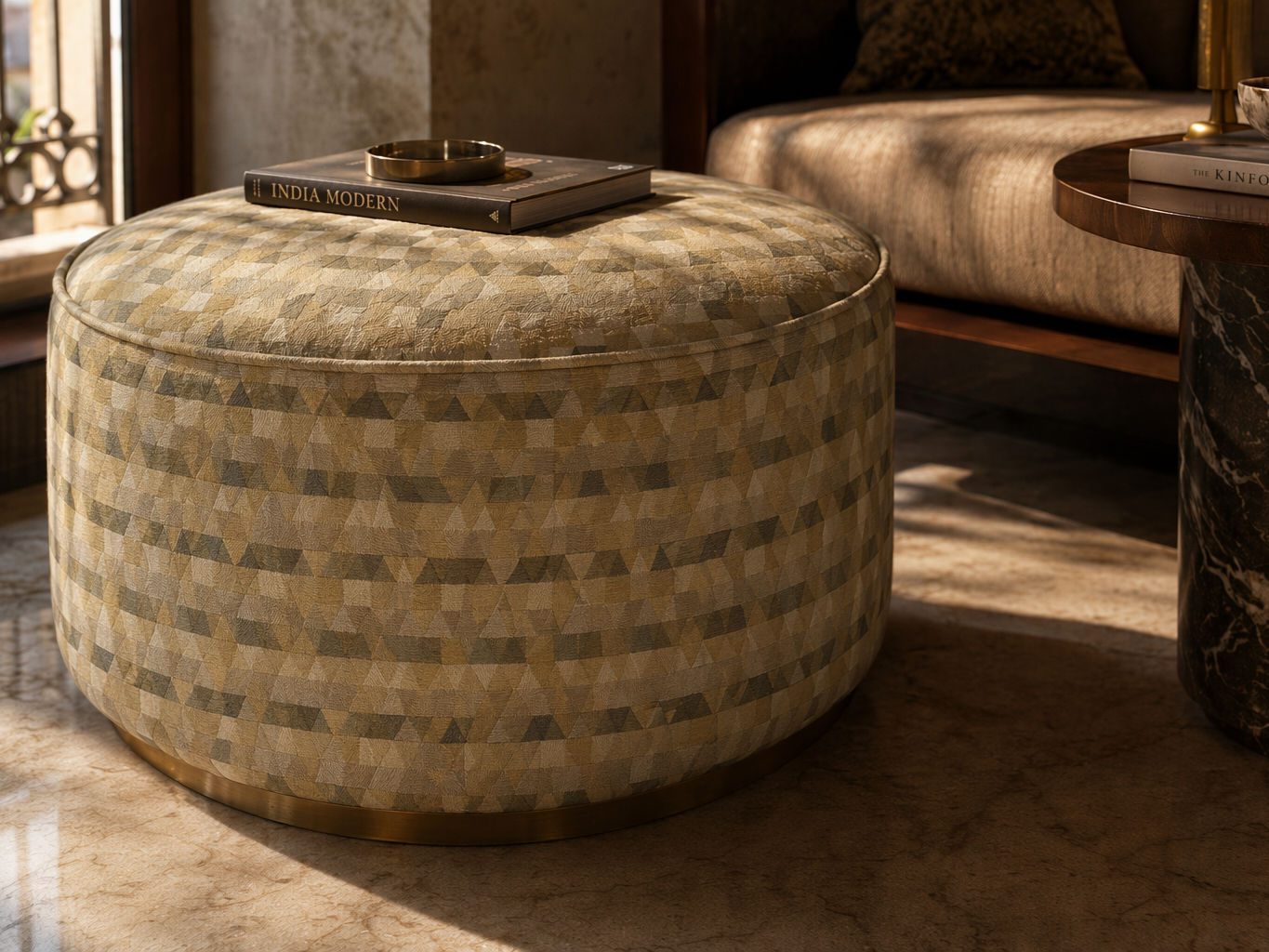 Round upholstered ottoman with a multitone geometric pattern in mustard, olive, cream, and grey - Beautiful Homes