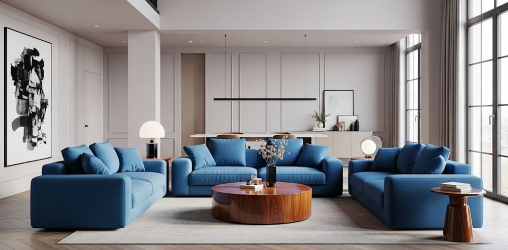 Living room with blue sofas and wooden table - Beautiful Homes