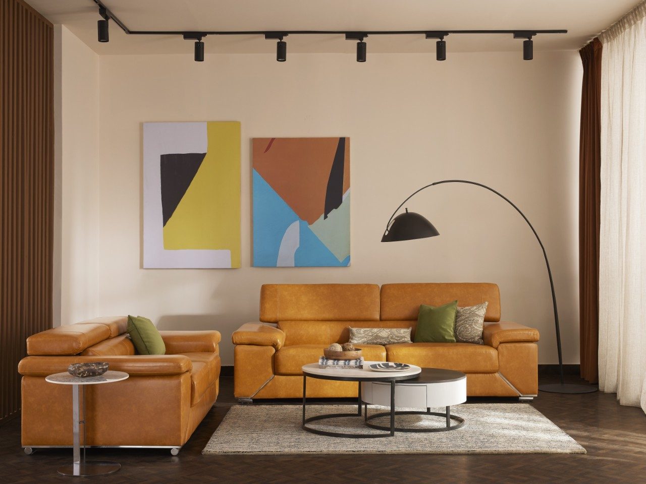 Living room with leather sofa and abstract art - Beautiful Homes