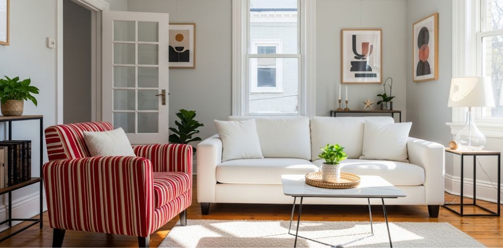 Modern living room with white sofa and striped chair - Beautiful Homes