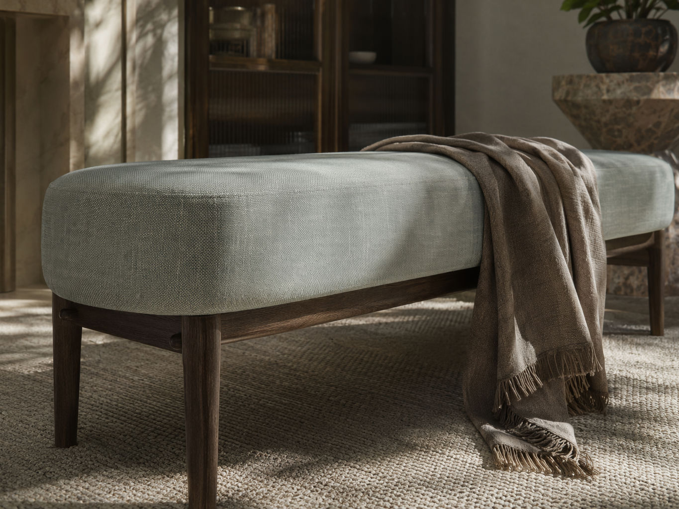 Contemporary bench with a rounded sage green upholstered seat, dark wooden frame, and tapered legs - Beautiful Homes