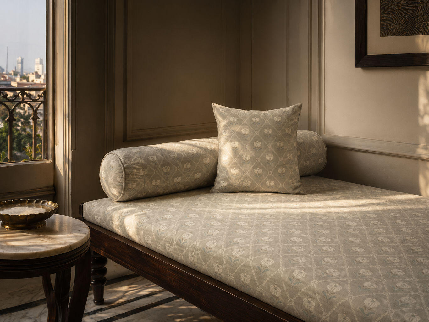 Dark wooden daybed with a patterned upholstered mattress, matching bolster cushion, and accent pillow - Beautiful Homes
