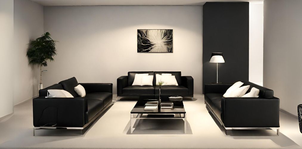 Simple living room with black leather sofa and white cushions-Beautiful Homes