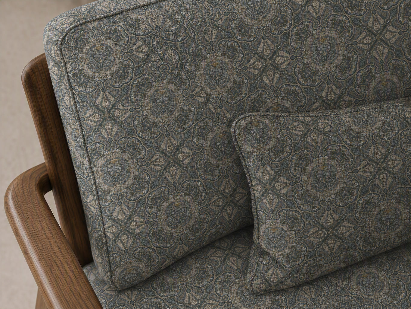 Close-up of an armchair featuring slate blue and gold ornamental pattern upholstery with a matching cushion - Beautiful Homes